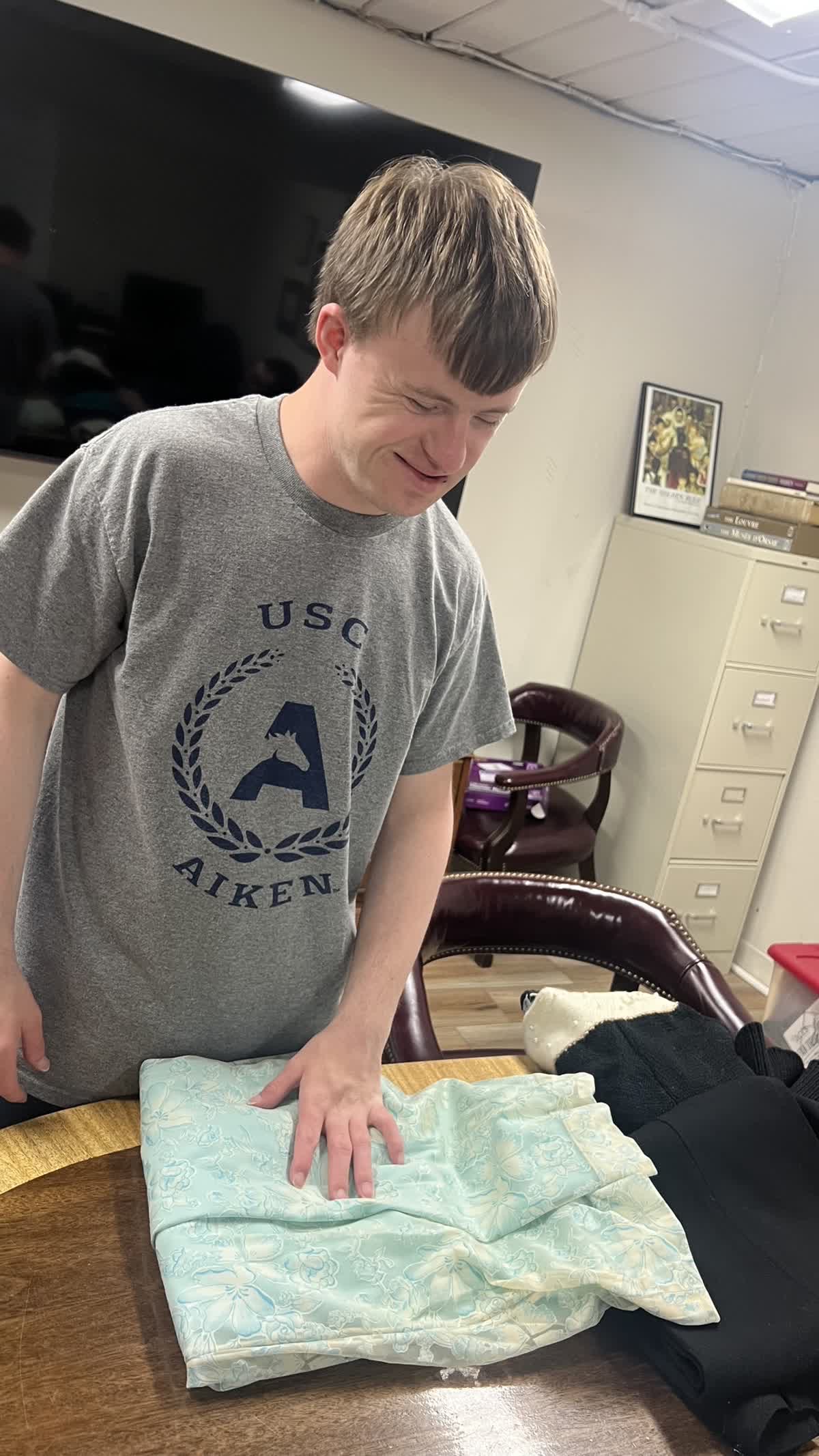 LIFE student sorting through donations at ACTS Thrift Store.